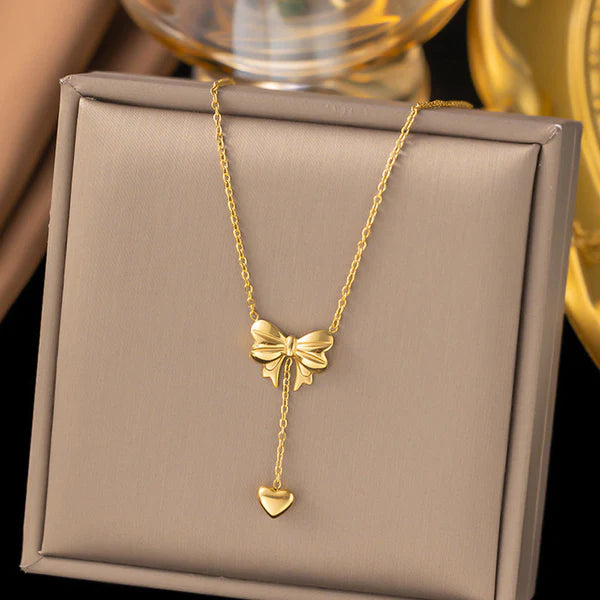Svarnika Jewels Gold Plated Stainless Steel Anti Tarnish Heart Themed Bow Inspired Pendant Necklace