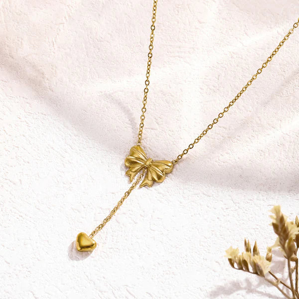 Svarnika Jewels Gold Plated Stainless Steel Anti Tarnish Heart Themed Bow Inspired Pendant Necklace