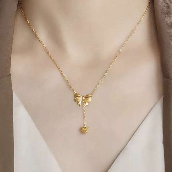 Svarnika Jewels Gold Plated Stainless Steel Anti Tarnish Heart Themed Bow Inspired Pendant Necklace