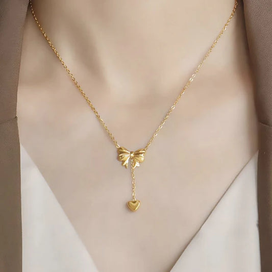 Svarnika Jewels Gold Plated Stainless Steel Anti Tarnish Heart Themed Bow Inspired Pendant Necklace